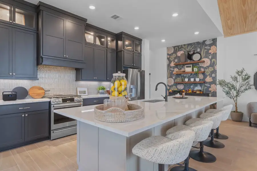 Furnished interior in a model home at Attwater 65's in Waller (Image 4).