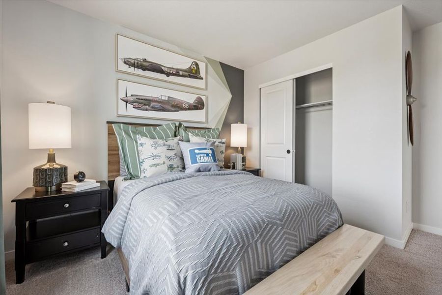 A bedroom with a bed and lamps.