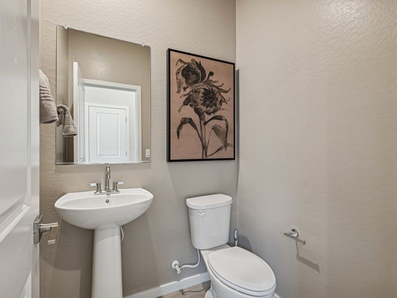 A bathroom with a toilet and sink.