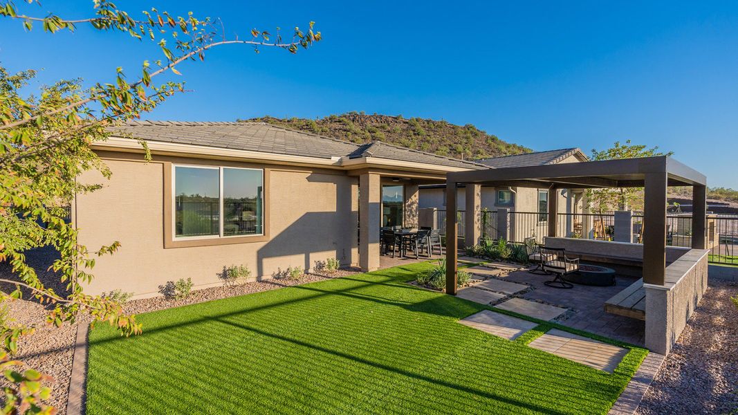 Elegant pergola and pristine lawn define the luxurious outdoor space at The Villas at Mystic, Arizona.