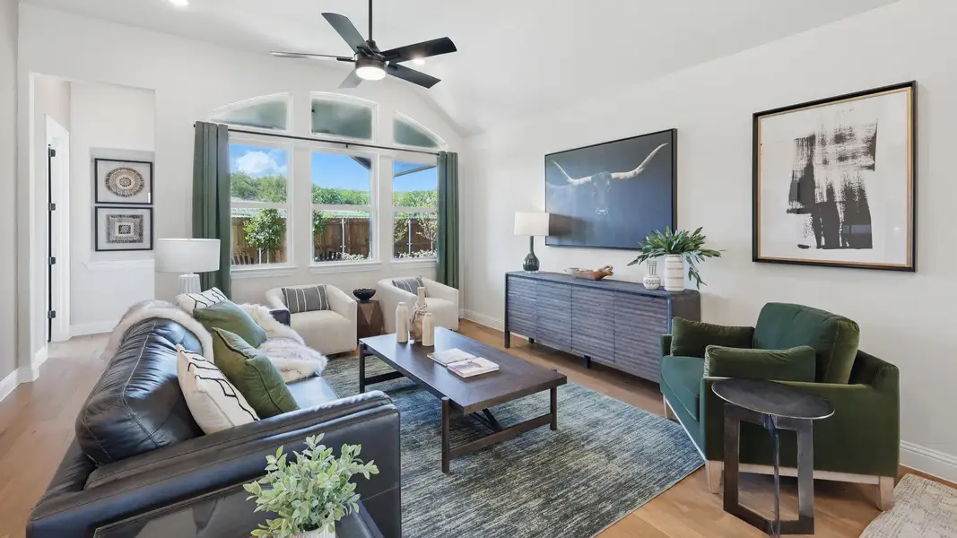 Inviting living room with vaulted ceilings, abundant natural light, and stylish modern finishes. Inviting living room with vaulted ceilings, abundant natural light, and stylish modern finishes.