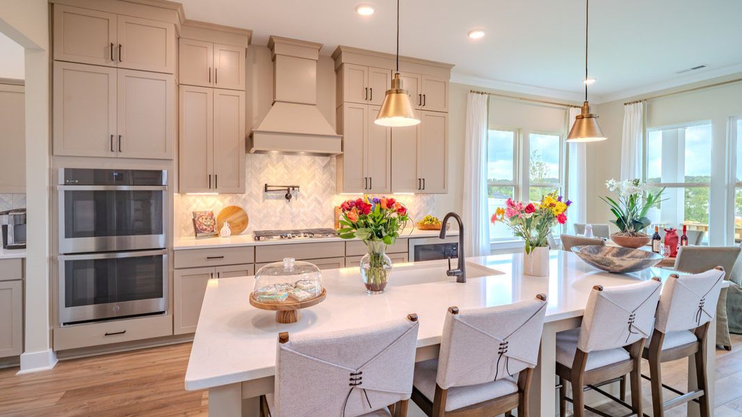 Large gourmet kitchen with standard upgraded appliances, quartz countertops, and ceramic tile backsplash Large gourmet kitchen with standard upgraded appliances, quartz countertops, and ceramic tile backsplash