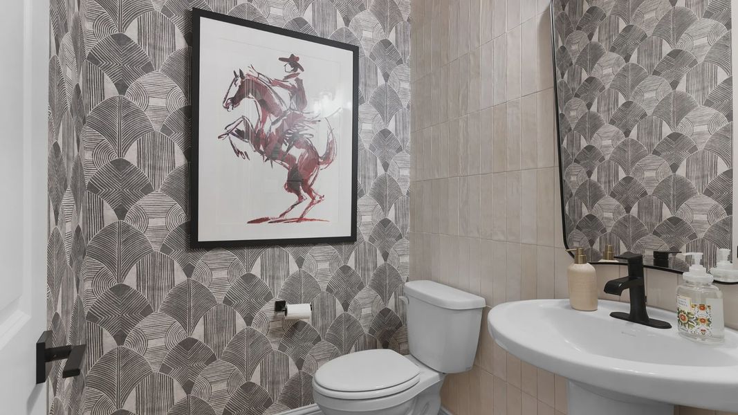 Stylish powder room near the entryway with modern finishes and convenient guest access.
