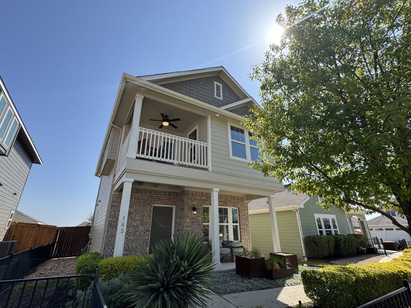A charming two-story home with a cozy balcony and lush landscaping in Trace by Pacesetter Homes (San Marcos, TX). A charming two-story home with a cozy balcony and lush landscaping in Trace by Pacesetter Homes (San Marcos, TX).
