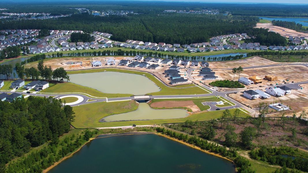 Aerial view of the The Coves at Lakes of Cane Bay community in Summerville, SC, showing layout and nearby surroundings (Image 15). Aerial view of the The Coves at Lakes of Cane Bay community in Summerville, SC, showing layout and nearby surroundings (Image 15).
