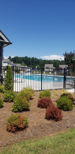 A beautiful community pool with landscaped surroundings in Timber Ridge: Timber Ridge 42' by Lennar (Douglasville, GA).
