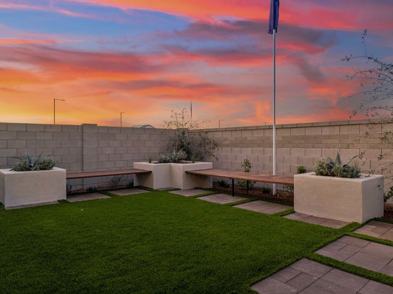 A wall with a flag and a tree in the front.