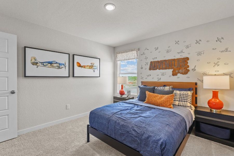 A bedroom with a bed and lamps.