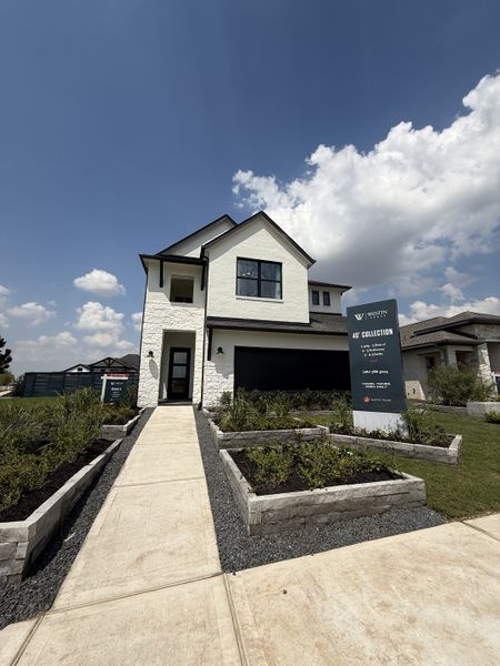 A modern white brick home with sleek design in Austin Point - 60' by Westin Homes (Richmond, TX).