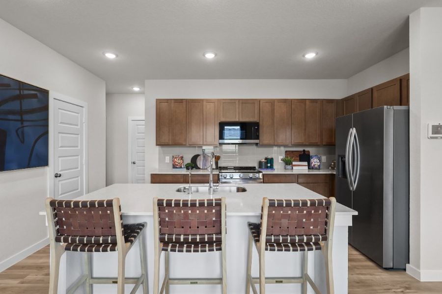 A kitchen with a table and chairs.