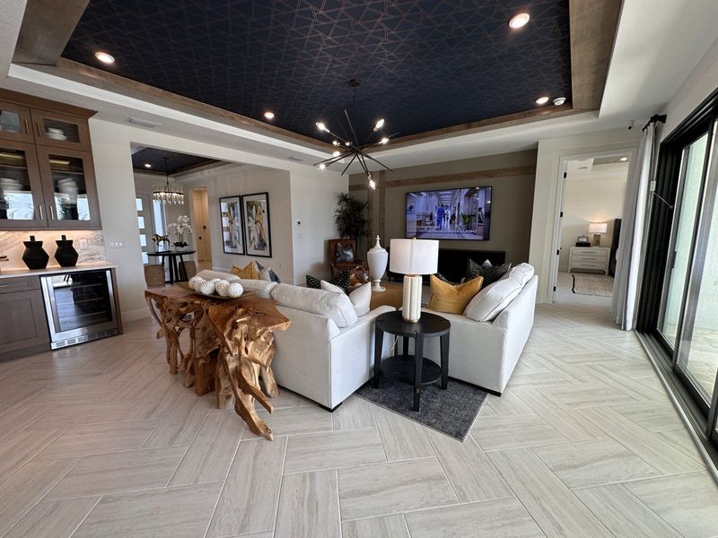 A chic living area with textured ceiling, modern seating, and unique wooden furniture creates a cozy, stylish retreat.