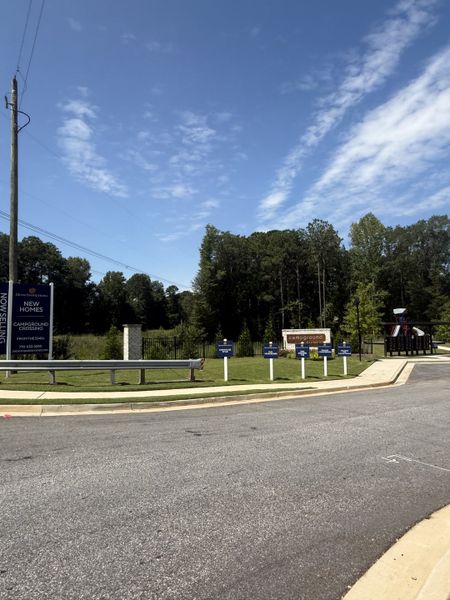 Entrance to Campground Crossing by Dream Finders Homes, McDonough, GA, with lush greenery and clear skies. Entrance to Campground Crossing by Dream Finders Homes, McDonough, GA, with lush greenery and clear skies.