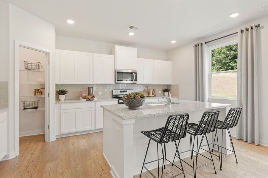 A kitchen with white cabinets. A kitchen with white cabinets.