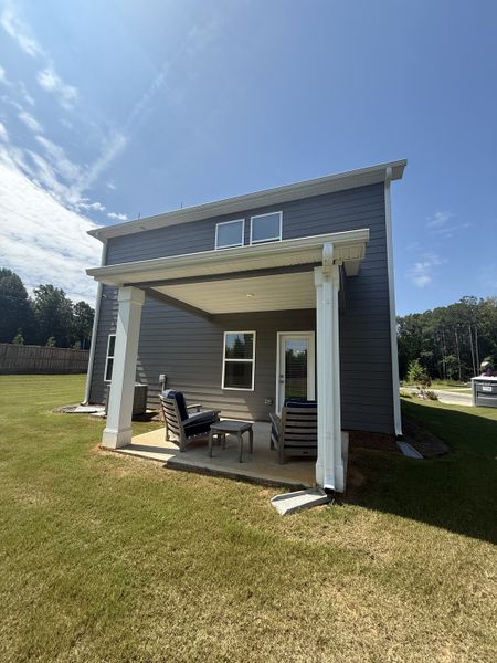 A modern gray home with a cozy backyard patio in Campground Crossing by Dream Finders Homes (Mcdonough, GA). A modern gray home with a cozy backyard patio in Campground Crossing by Dream Finders Homes (Mcdonough, GA).