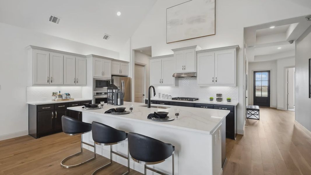 Elegant marble island with state-of-the-art appliances enhances this Westside Preserve kitchen's sophistication.