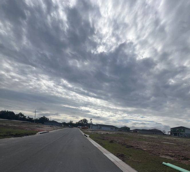 A developing neighborhood under a cloudy sky in Reserve at Forest Lake Townhomes by KB Home (Lake Wales, FL).