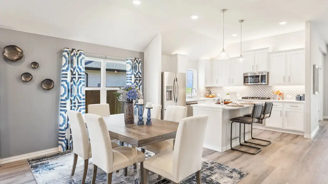 Luxurious kitchen featuring chic white cabinetry and premium wood flooring in Texas home.