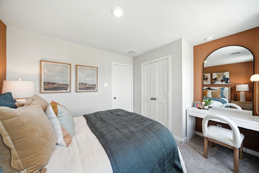 A bedroom with a bed and a desk. A bedroom with a bed and a desk.