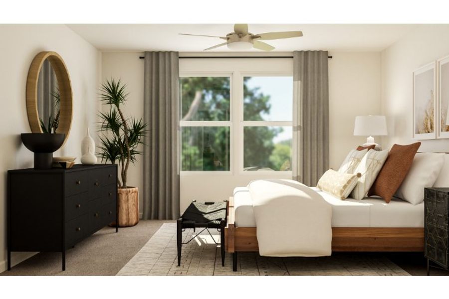 A living room with a white couch and a white table.