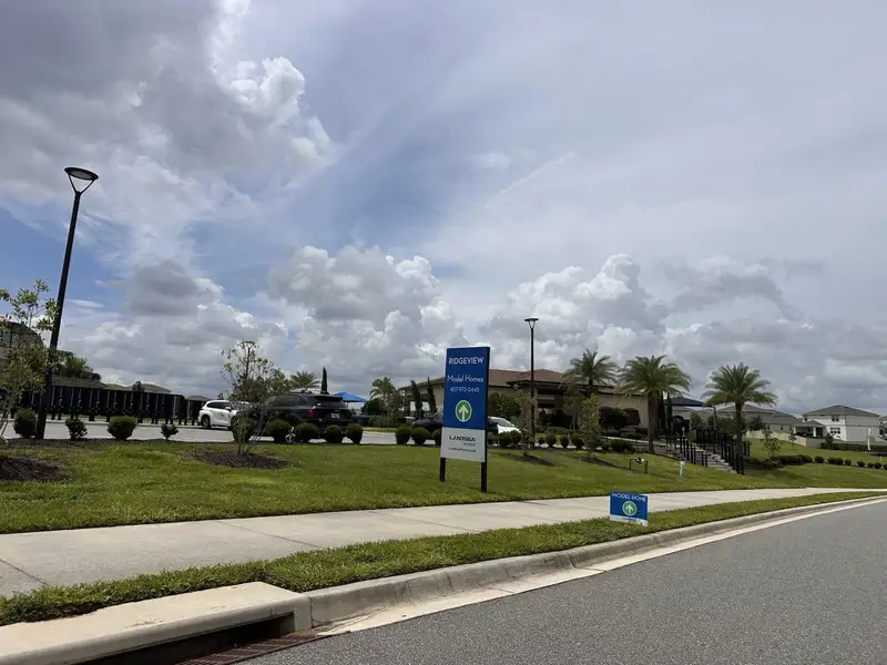 Scenic community entrance with lush landscaping in Ridgeview by Landsea Homes (Clermont, FL).