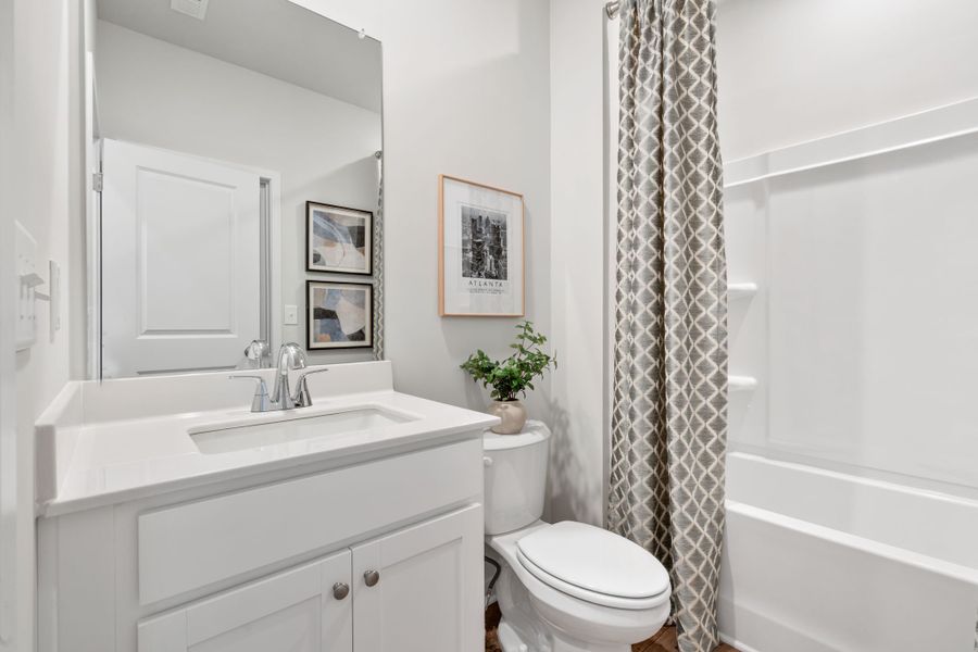 A bathroom with a shower curtain.