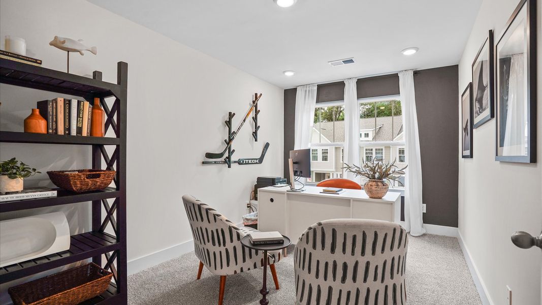 Plush carpeted, cozy secondary bedroom with large windows and elevated ceilings at Clayton Crossing by DRB Homes in Arden, NC Plush carpeted, cozy secondary bedroom with large windows and elevated ceilings at Clayton Crossing by DRB Homes in Arden, NC