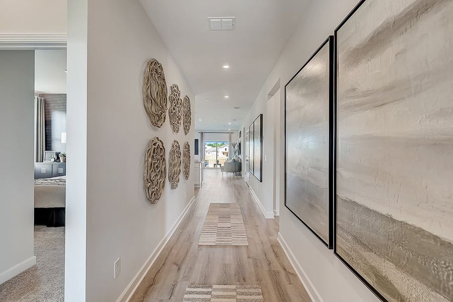 A hallway with a wood floor. A hallway with a wood floor.