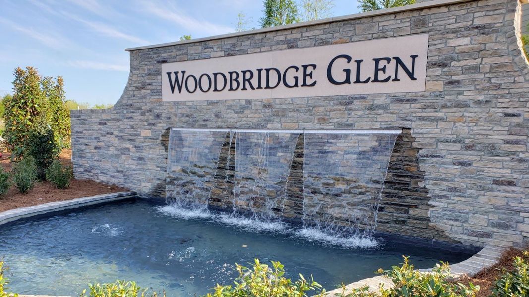 Entrance to the Woodbridge Glen Townhomes community in Lebanon, TN, featuring signage and landscaping (Image 1).
