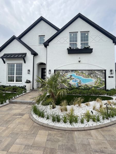 A stunning white brick home with lush landscaping in Santorini by Megatel Homes (Seagoville, TX). A stunning white brick home with lush landscaping in Santorini by Megatel Homes (Seagoville, TX).