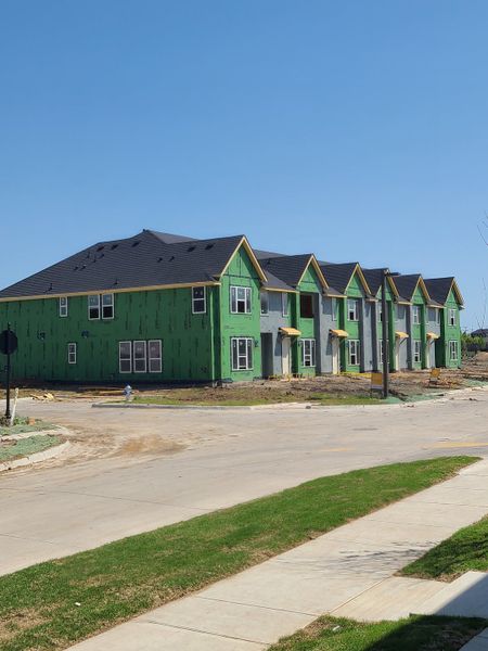 A modern, green-sided building under construction in Chelsea Commons by Cadence Homes (Allen, TX). A modern, green-sided building under construction in Chelsea Commons by Cadence Homes (Allen, TX).