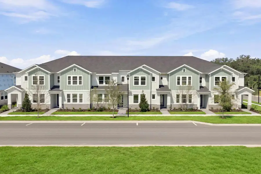 Front exterior of a home in the Palmeras at Crossprairie – The Palms Collection community, located in St. Cloud, FL (Image 3).
