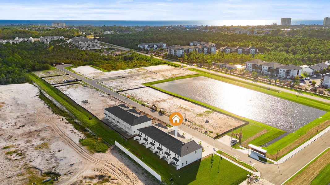 Aerial view of the Colonial East Townhomes community in Panama City Beach, FL, showing layout and nearby surroundings (Image 1).