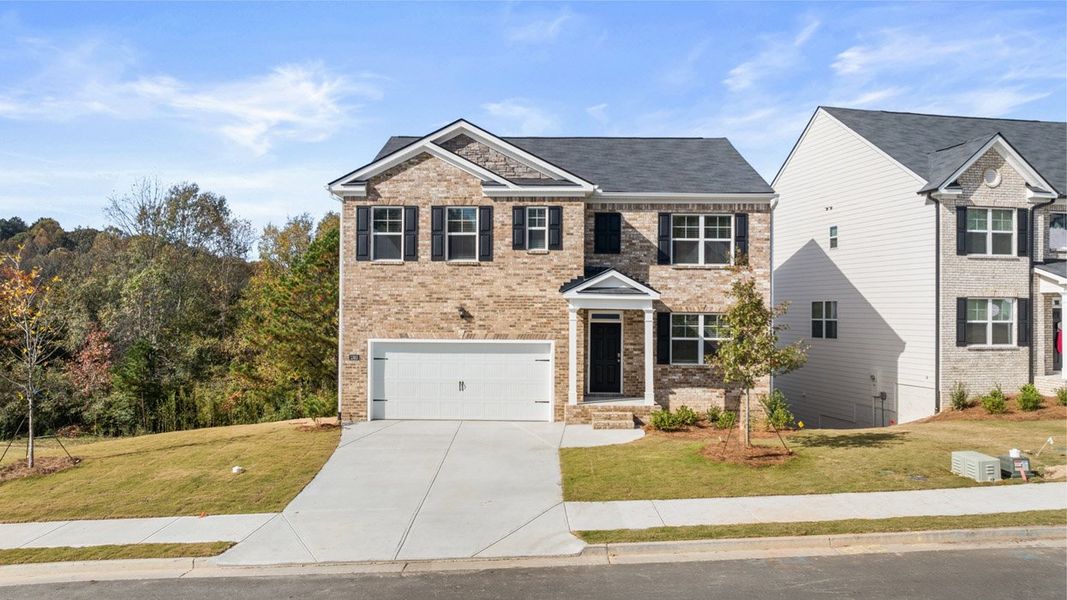 Front exterior of a home in the Brooks Village community, located in Dacula, GA (Image 12).