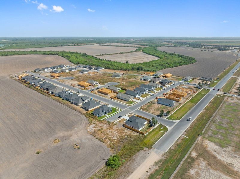 Aerial view of the The Heights at Riverbend II community in Brownsville, TX, showing layout and nearby surroundings (Image 10). Aerial view of the The Heights at Riverbend II community in Brownsville, TX, showing layout and nearby surroundings (Image 10).
