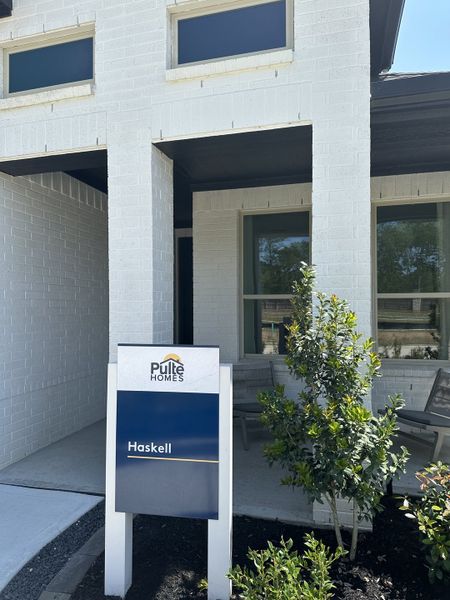 A modern white brick home in Montgomery Bend by Pulte Homes, featuring a stylish porch and lush greenery (Montgomery, TX). A modern white brick home in Montgomery Bend by Pulte Homes, featuring a stylish porch and lush greenery (Montgomery, TX).