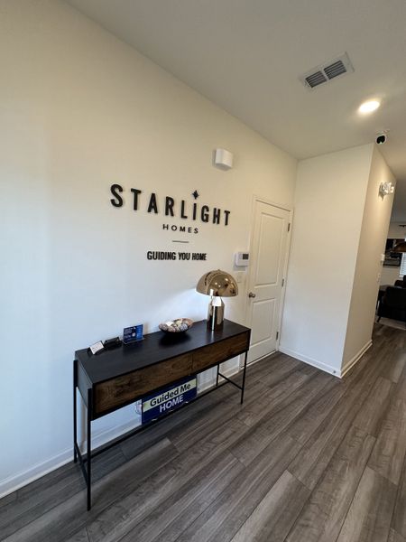 A welcoming entryway with sleek flooring, a modern console table, and stylish decor accents.