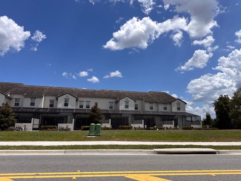 Front exterior of a home in the The Enclaves at Festival Cove community, located in Davenport, FL (Image 5).