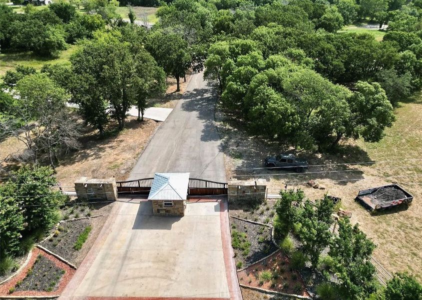 Entrance to the Woodland Lakes community in Weatherford, TX, featuring signage and landscaping (Image 13). Entrance to the Woodland Lakes community in Weatherford, TX, featuring signage and landscaping (Image 13).