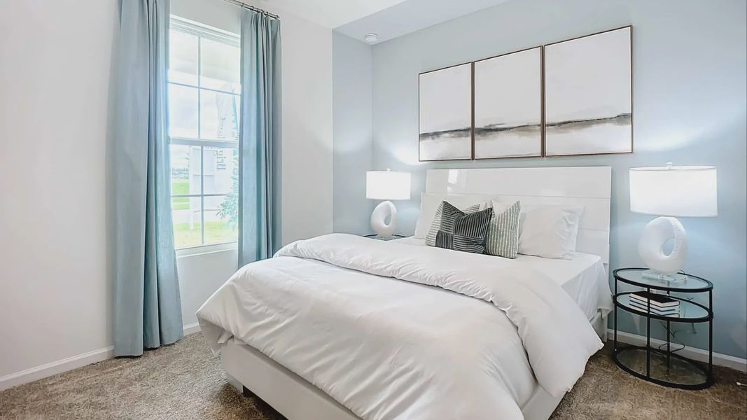 Luxurious bedroom features serene blue walls and plush carpet, offering tranquil elegance in Panther Creek.