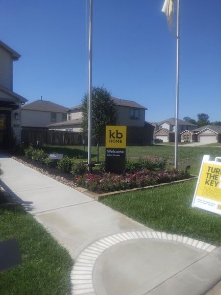 A manicured garden and inviting entrance at Glendale Lakes North by KB Home in Arcola, TX.