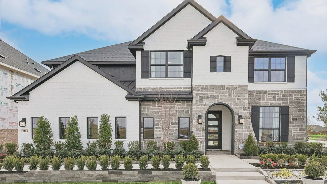 Sophisticated brick and stone facade with an arched entry in Green Meadows. Sophisticated brick and stone facade with an arched entry in Green Meadows.