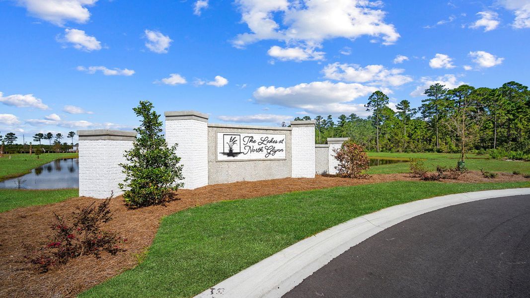 Entrance to the The Lakes at North Glynn community in Brunswick, GA, featuring signage and landscaping (Image 12).
