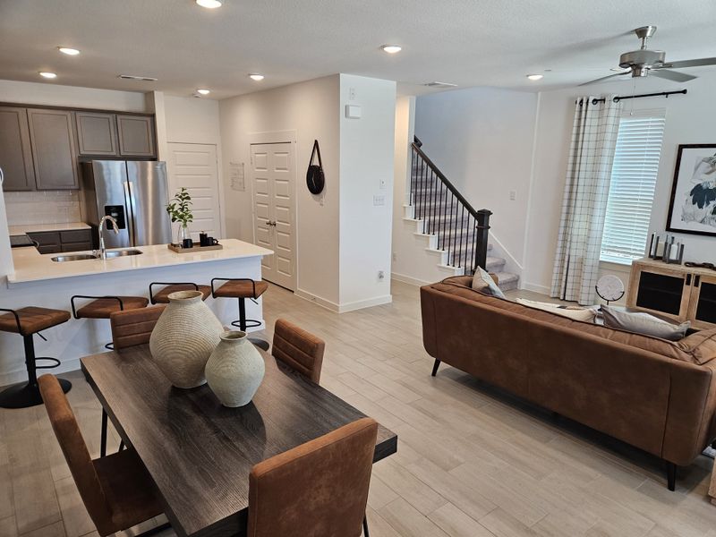 Open-plan interior with modern kitchen, cozy seating area, and stylish dining set. Bright and inviting space with natural light. Open-plan interior with modern kitchen, cozy seating area, and stylish dining set. Bright and inviting space with natural light.