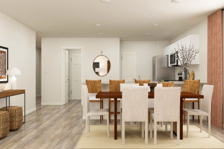 A dining room with a table and chairs.