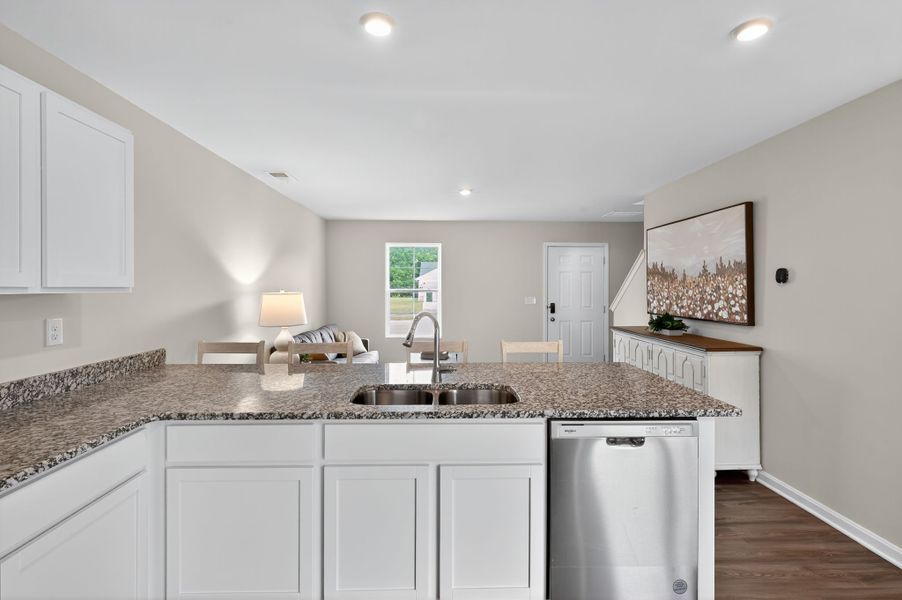 A kitchen with marble counters.