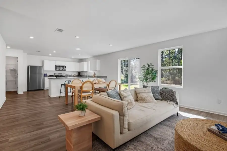 A living room with a couch and a table. A living room with a couch and a table.