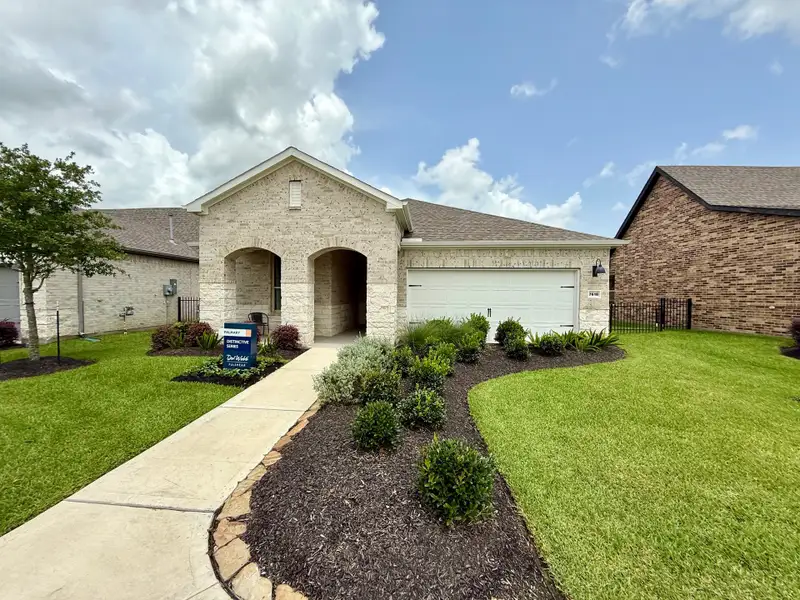 A charming brick home with an arched entry and manicured lawn in Del Webb Fulshear by Del Webb (Fulshear, TX). A charming brick home with an arched entry and manicured lawn in Del Webb Fulshear by Del Webb (Fulshear, TX).