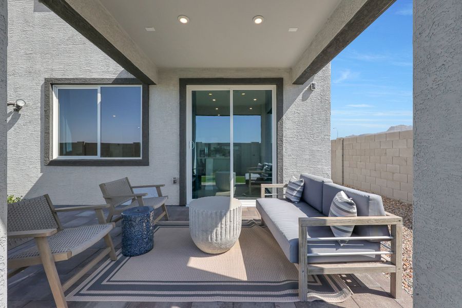 A living room with a couch and chairs. A living room with a couch and chairs.