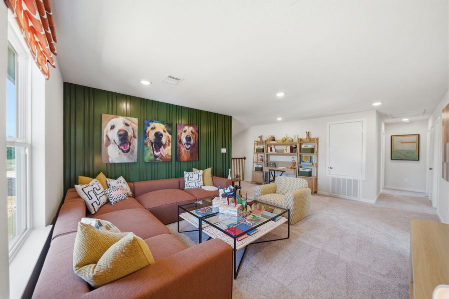 A living room with a green wall. A living room with a green wall.