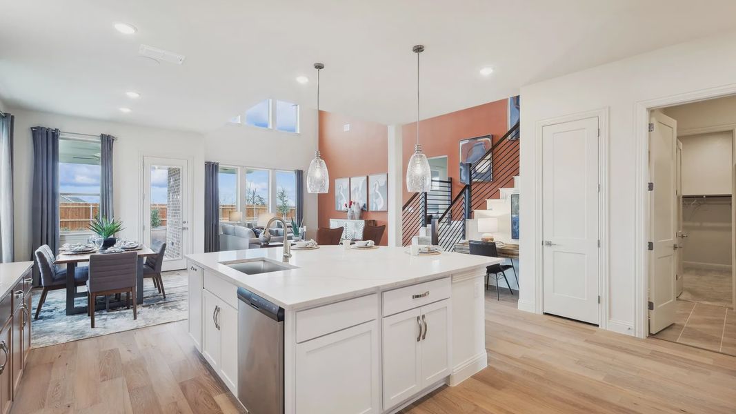 Experience bespoke elegance with a quartz-topped island and luxurious hardwood flooring in The Oaks.